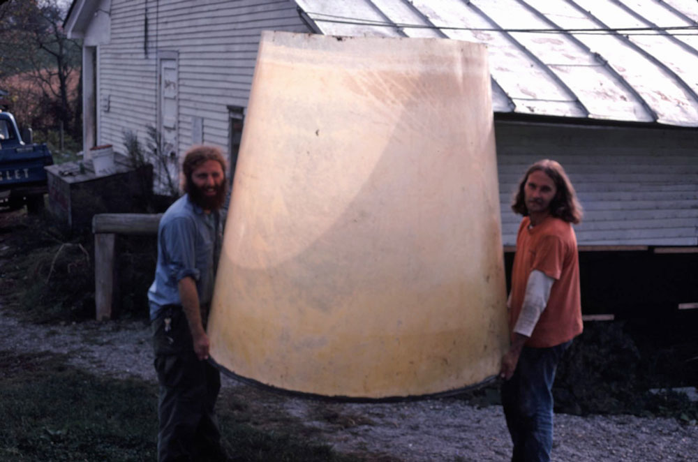 Dr. Barry Costa-Pierce (right) and friend carrying the solar algae pond to set it up.